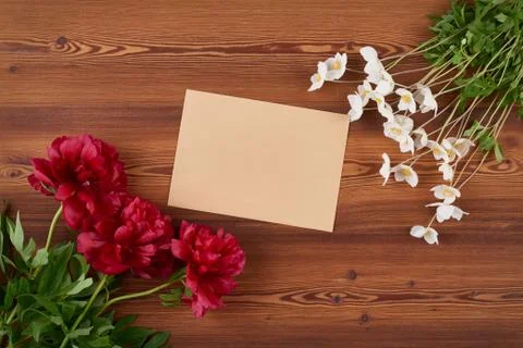 Top view envelope and spring flowers on wooden background Stock Photos