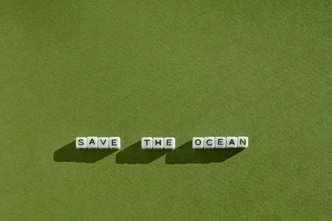 Top view of the environmental slogan Save the Ocean laid out in white cubes w Fotos Stock