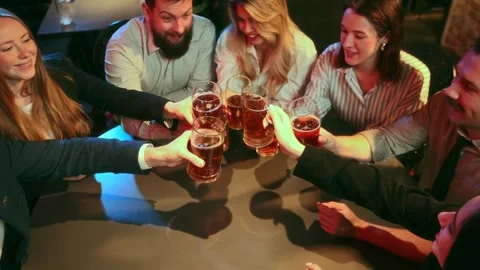 Top view. Evening fun. Colleagues, friends meeting at pub sitting at table Stock Footage 263448505