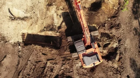 Top View of an excavator operating on a hillside Stock Footage 336327463