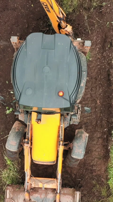 Top view of excavator working in field. Clip. Bulldozer clears plot of land with Stock Footage 289467683