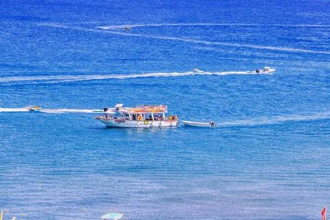 Top view of excursion boat POPAI with people cruising Aegean Sea. Stock Photos