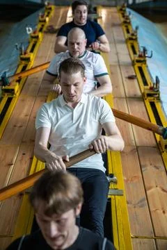 Top view exhausted determined rowers push limits training intensely on rowing Stock Photos