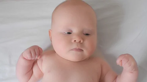 Top view face of adorable cute little child lying on bed looking at camera Video stock 129680830