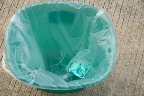 Top view of face mask  in garbage bin Stock Photos