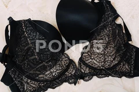 Top view of fashionable women's different brassiere on beige background with Stock Photos