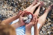 Top View Of Father And Small Daughter On A Holiday Sitting By The Lake Stock Photos