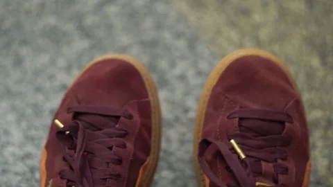 Top view on female feets weared in sneakers. Female sitting, feets in air Stock Footage 204791048