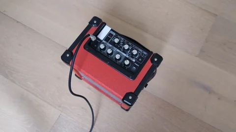 Top view of female hand adjusting knobs and plugging guitar cord into amplifi 스톡 동영상 126192018