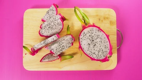 Top view, female hand cuts the fruit with a knife on a wooden board, white Stock Footage 100408976