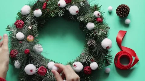 Top view female hands decorate a christmas wreath Stock Footage 219854486