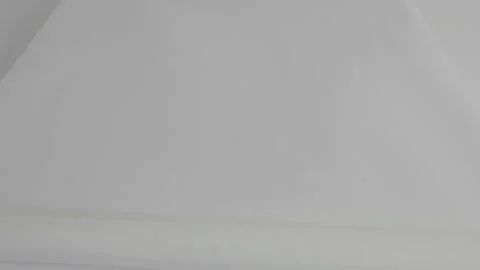 Top view. Female hands deploy a skein of white fabric in white. Open large roll Stock Footage 107968794