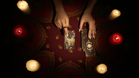 Top view, female hands picking three tarot cards from the deck and laying them Stock Footage 247979033