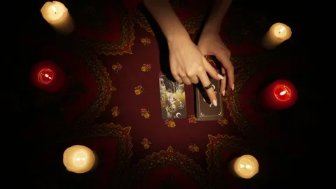 Top view, female hands picking few tarot cards from the deck and laying them on Stock Footage 247979187