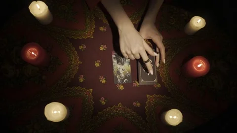 Top view, female hands picking few tarot cards from the deck and laying them on Stock Footage 248003464