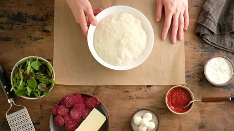 Top view, female hands pour flour and put dough, prepare Italian pizza with Stock Footage 132360928