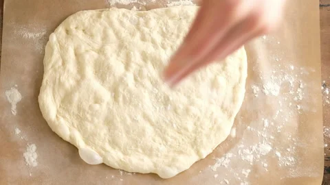 Top view, female hands put dough, prepare Italian pizza with sauce, tomatoes Stock Footage 132361237