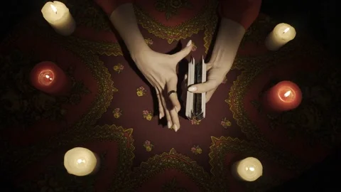 Top view, female hands shuffling tarot cards and picking one card from the deck Stock Footage 248003238