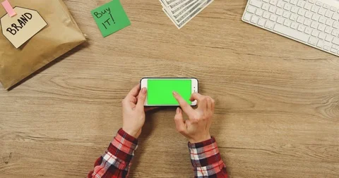 Top view on the female hands taping on the white horizontal smartphone with a Stock Footage 89952368