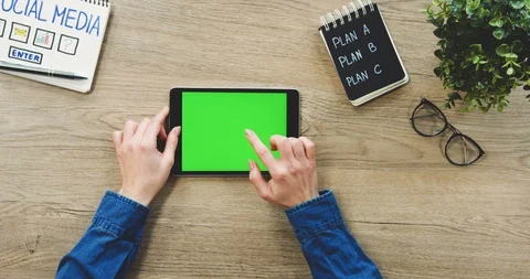 Top view on the female hands taping on the black tablet device with a green 스톡 동영상 89982190