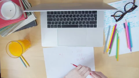 Top view female hands typing on keyboard, writing on paper with pencil. Working Stock Footage 135085671