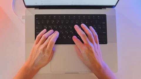 Top view of female hands typing on laptop keyboard at desk, working on computer Stock Footage 333764960