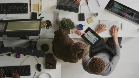 Top View of Female Programmer Discussing HTML Code with Colleague Stock Footage 255781975