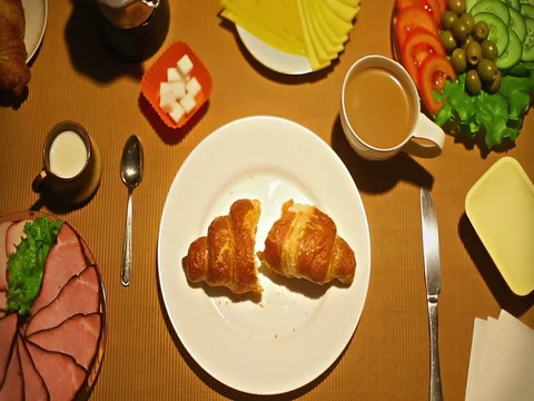 Top view female taking a bite of croissant for breakfast Stock Footage 73256864