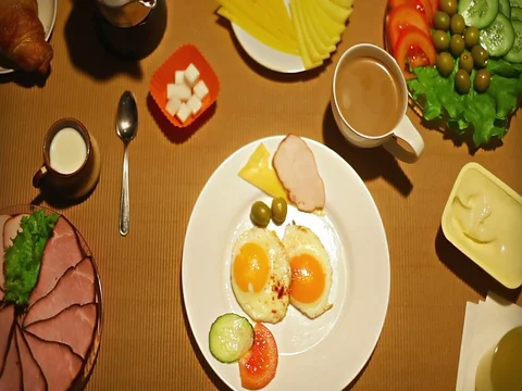 Top view female taking a ham slice from the plate at breakfast Stock Footage 73258584