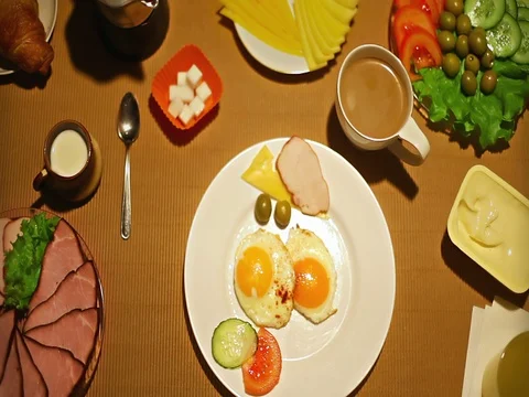 Top view female taking an olive from the plate at breakfast Stock Footage 73257966
