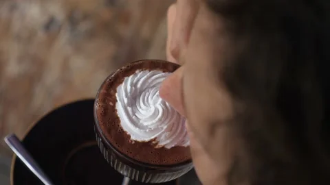 Top view of female taking a sip of vegan hot chocolate with the cream on top Video stock 150102902