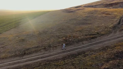 Top view of the fields and forest. Shooting from a quadcopter. A tourist goes Stock Footage 135255473
