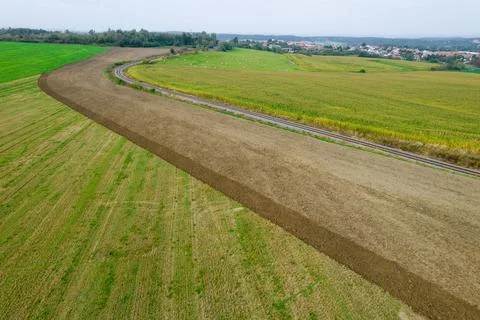 Top view of the fields and the railway in the village in the mountains. Stock Photos