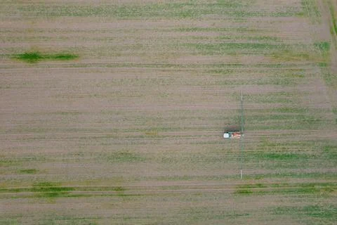 Top view of fields and tractor spraying grain. Fields background, place for Stock Photos
