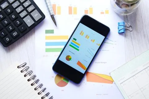 Top view of financial chart display on smart phone on table Stock Photos