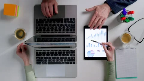 Top view of financial specialists discuss sales chart on digital tablet Stock Footage