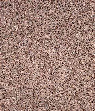 Top view of fine red granite crushed stone and decorative gravel coating in.. Stock Photos