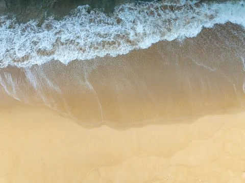 Top view of Fine sand texture natural background Waves crashing on sand Sum.. Photos