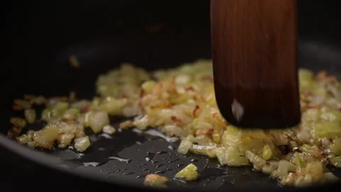 Top view of finely chopped onion fried in heat boiling vegetable oil in frying Stock Footage 196322855
