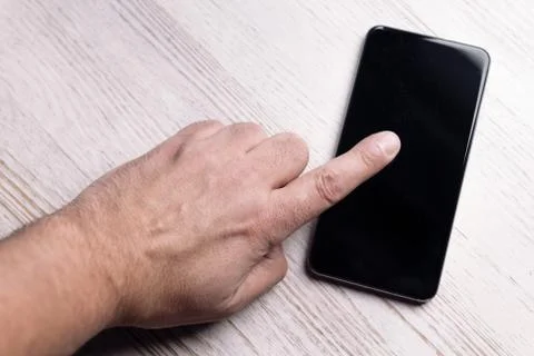 Top view of finger touching the screen of a phone Stock Photos