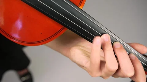 Top view fingers on violin strings. Close up girl in black dress playing violin Stock Footage 242944855
