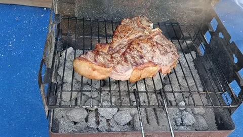 Top view on the fiorentina beef steak cooking on the bbq charcoal grill. Video stock 289633025