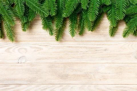 Top view of fir tree branches on wooden background. New Year holiday concep.. Stock Photos