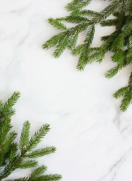 Top view fir tree branches frame on marble background. Christmas backdrop Stock Photos