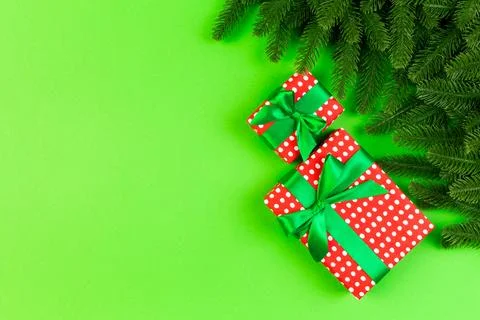 Top view of fir tree branches and gift box on colorful background. Christma.. Stock Photos