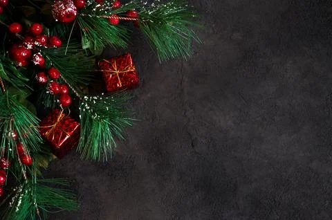 Top view on fir tree branches and gift boxes on dark background. Banner wit.. 写真素材