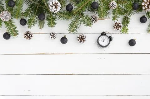 Top view of Fir tree with Pine cones and black balls on wooden table. Christmas Stock Photos