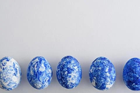 Top view five Easter eggs with blue gradient effect in row on white backgroun Stock Photos