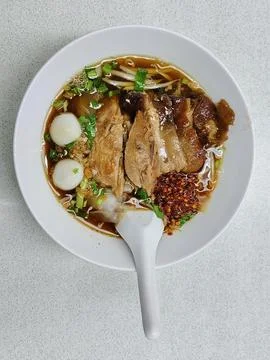 Top view of Five spice braised pork noodle in bowl on table. Stock Photos