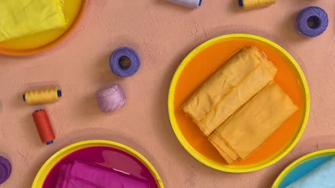 Top view of flasks with dyed fabrics in bright colors fabric master class concep Stock Footage 306208340